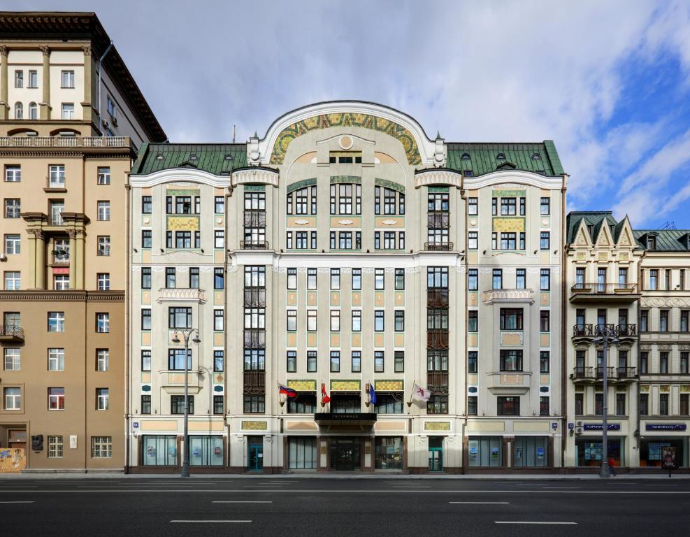 a large building with a clock on the side of it at Moscow Marriott Tverskaya Hotel in Moscow