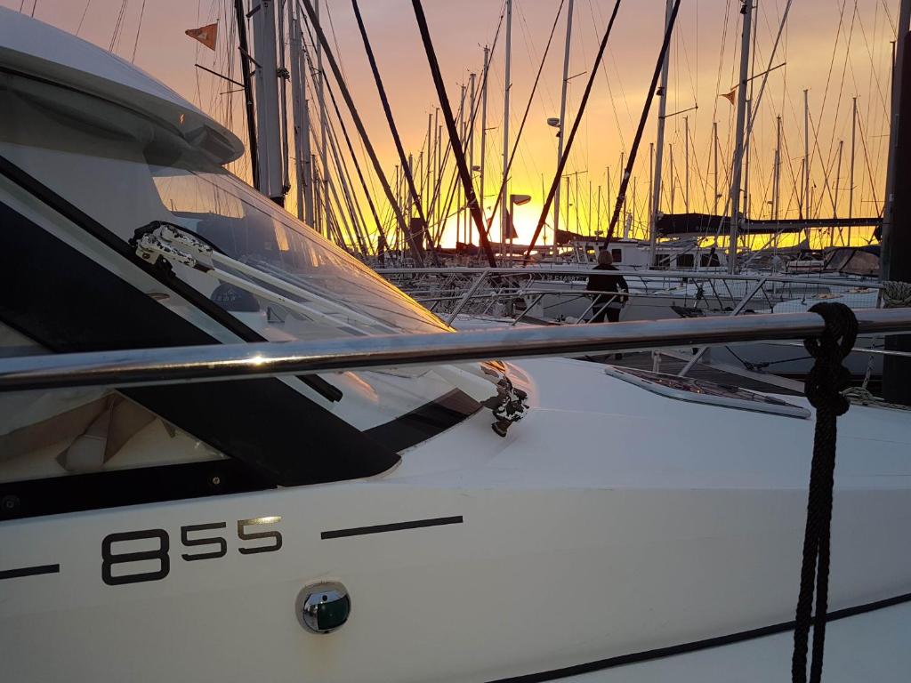 a boat is docked in a harbor at sunset at La Rochelle sur L'eau in La Rochelle