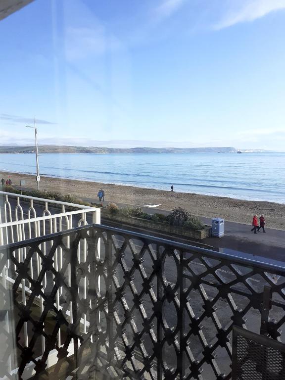 a view of the beach from a balcony at The Edenhurst Guesthouse in Weymouth