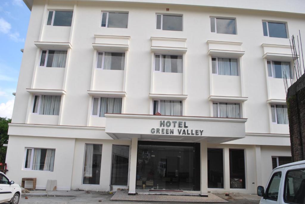 a white building with a sign that reads hotel green valley at Hotel Green Valley in Katra