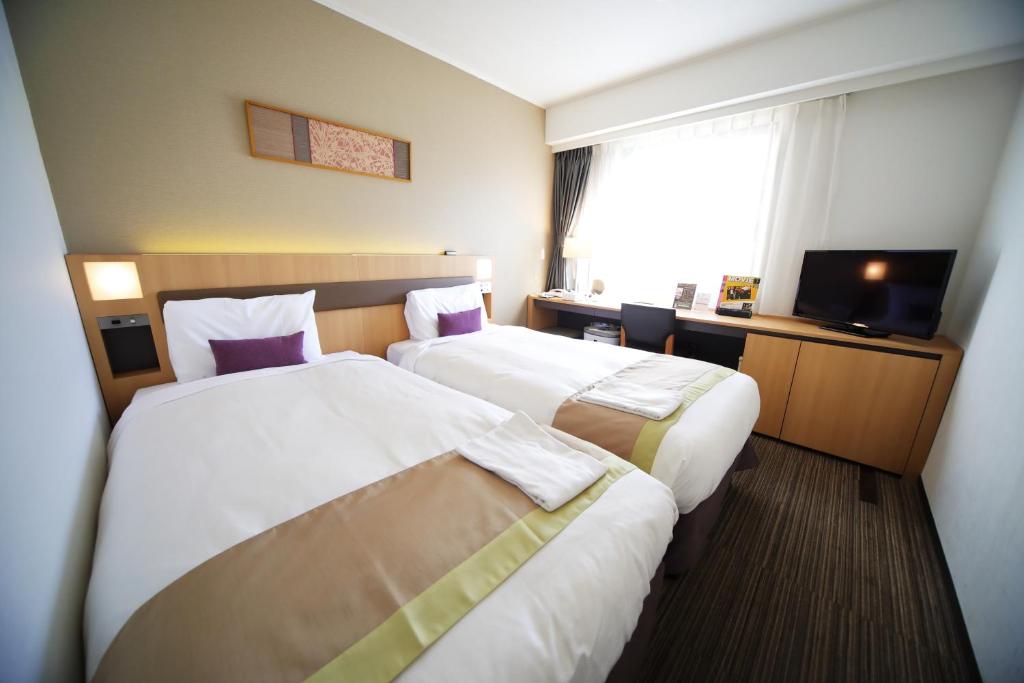 Postel nebo postele na pokoji v ubytování Hotel Sunroute Asakusa