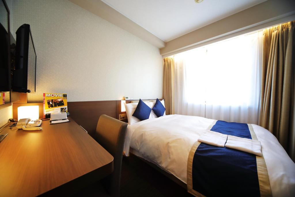 Postel nebo postele na pokoji v ubytování Hotel Sunroute Asakusa