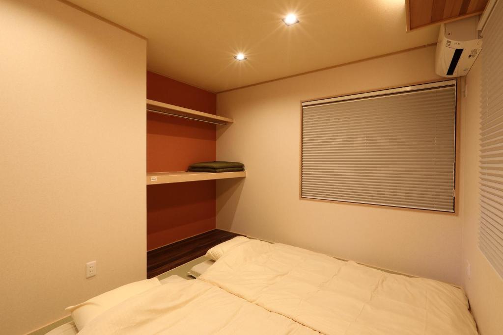 Letto o letti in una camera di ゲストハウス奈良庵 Nara An