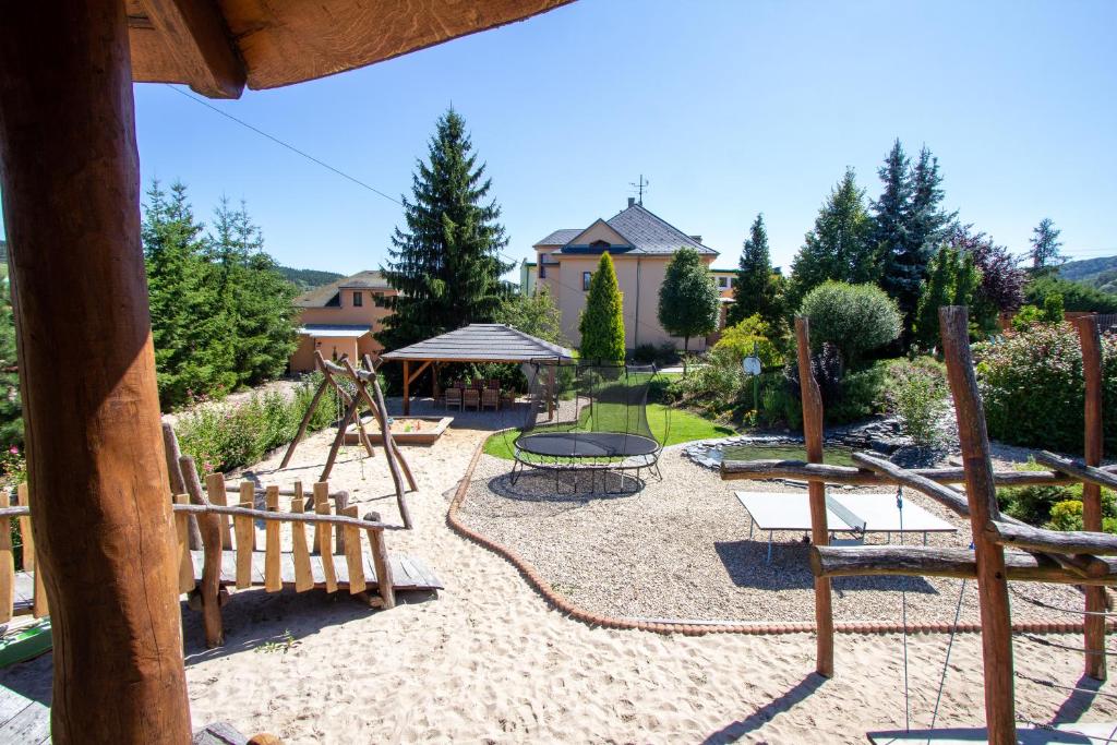 a backyard with a playground with a swing set at Apartmány PEMI Potštejn in Potštejn