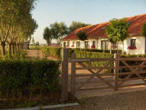 a wooden fence in front of a house at B&B Knotwilgenhoeve in Knokke-Heist