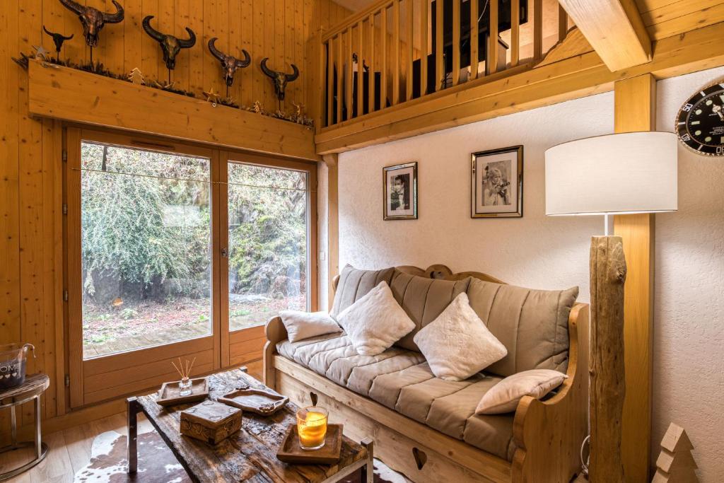 a living room with a couch and a table at Cocoon in Megeve in Megève