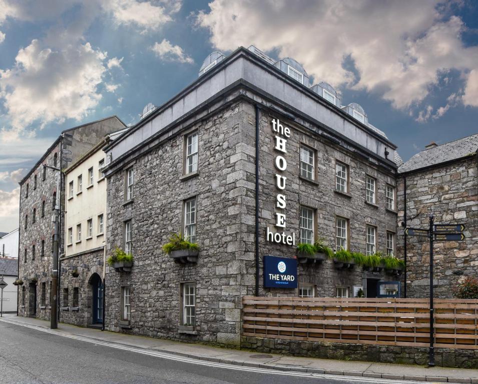 un edificio de ladrillo con un cartel en el costado en The House Hotel, an Ascend Hotel Collection Member en Galway