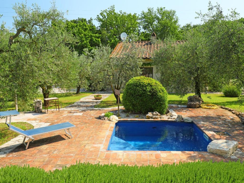 a pool in a yard with a bench and a house at Holiday Home Nest by Interhome in Penna in Teverina