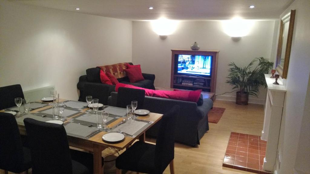 a living room with a table and a couch at Heart of Edinburgh's Historic Old Town - Blair Street in Edinburgh