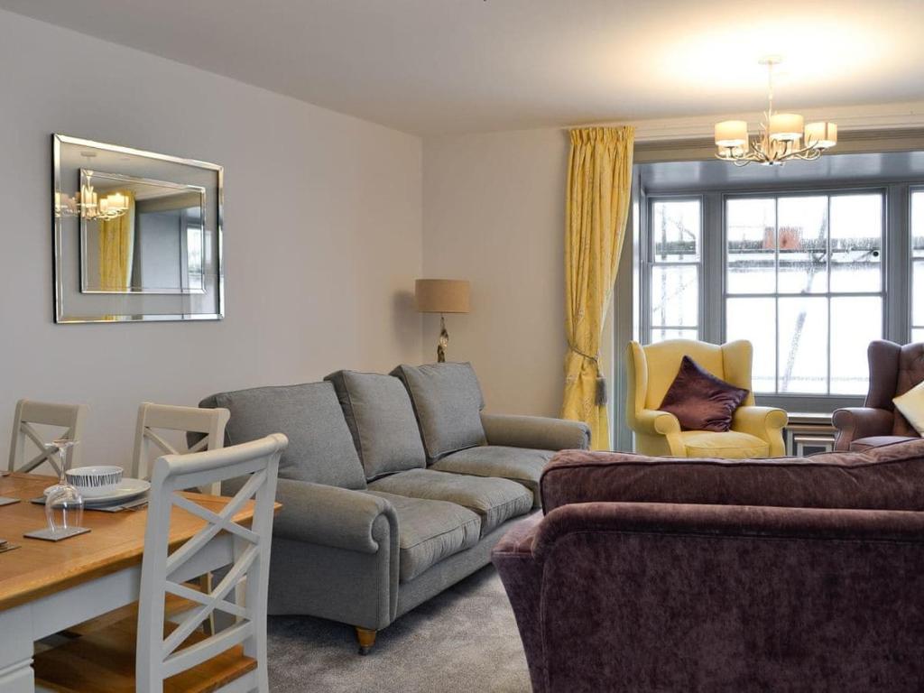 a living room with a couch and a table at Grosvenor House APT 2 in Aberystwyth