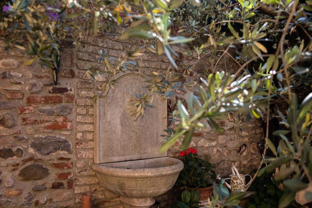 索姆馬隆巴爾多的住宿－A due passi dal Castello，砖墙里厕所的雕像