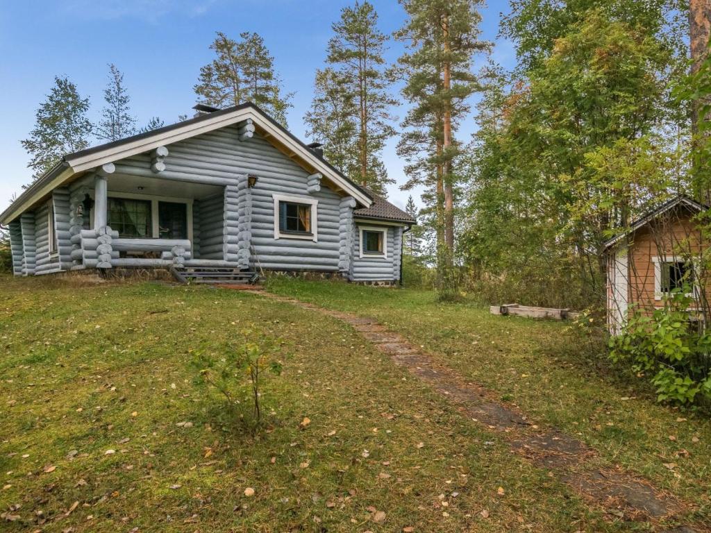 a small house on a hill in the woods at Holiday Home Harrila by Interhome in Huuhanaho