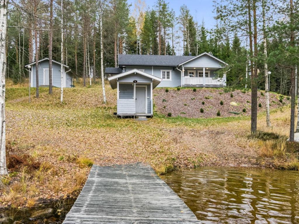 a house on top of a hill with a dock at Holiday Home Rinteelä by Interhome in Heinävesi