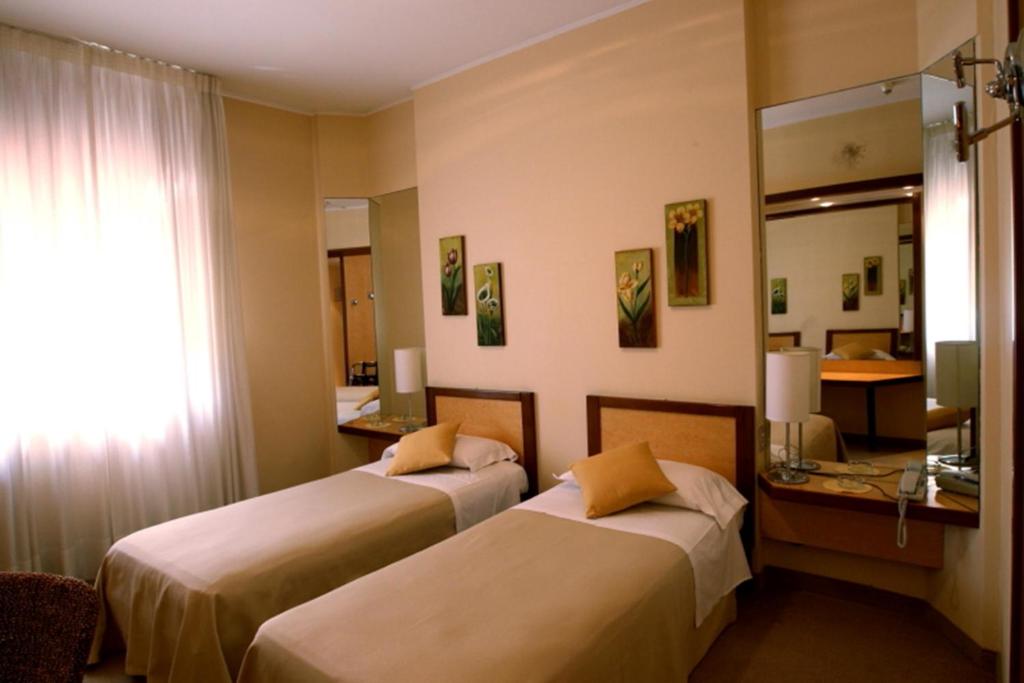 Postel nebo postele na pokoji v ubytování Hotel Globo