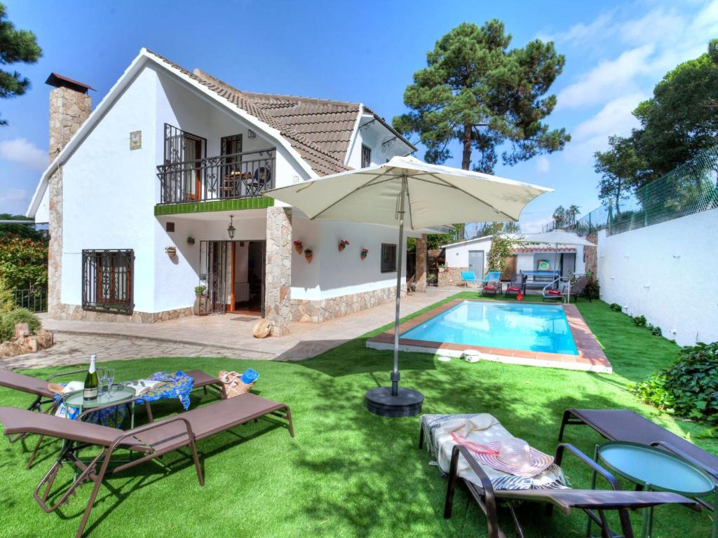 a villa with a swimming pool and a house at Holiday Home Paradis by Interhome in Mont Barbat