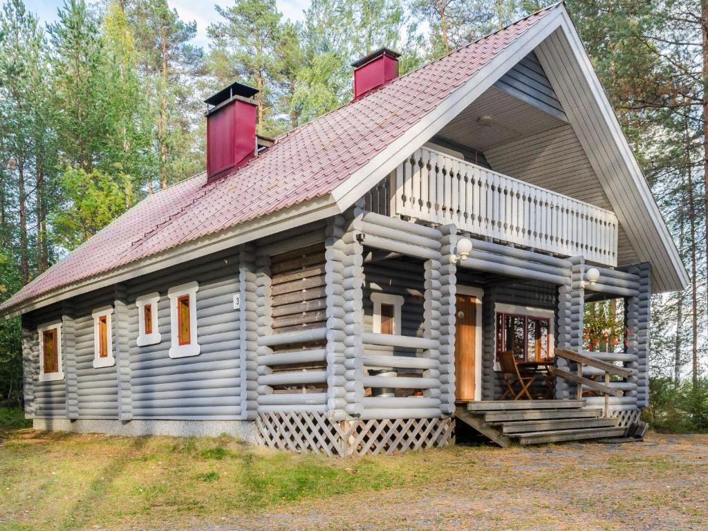 uma cabana de madeira com um telhado de gambrel em Holiday Home Metsätähti by Interhome em Ahmovaara