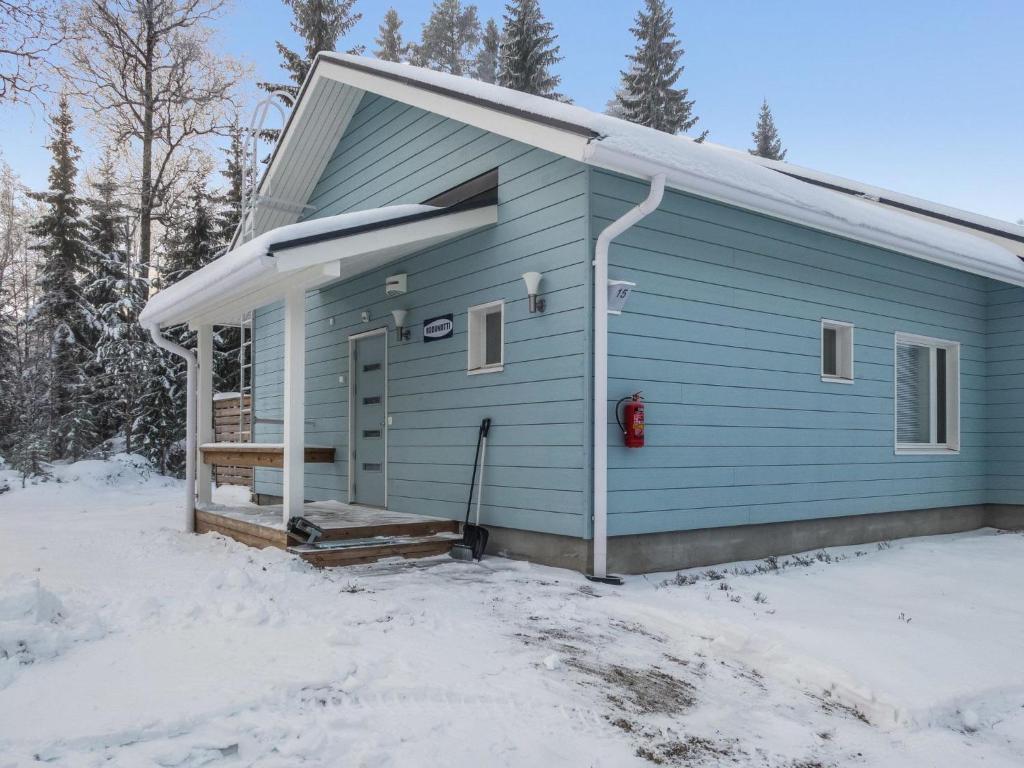 a blue house with snow on the ground at Holiday Home Klz rodoniitti by Interhome in Vuokatti