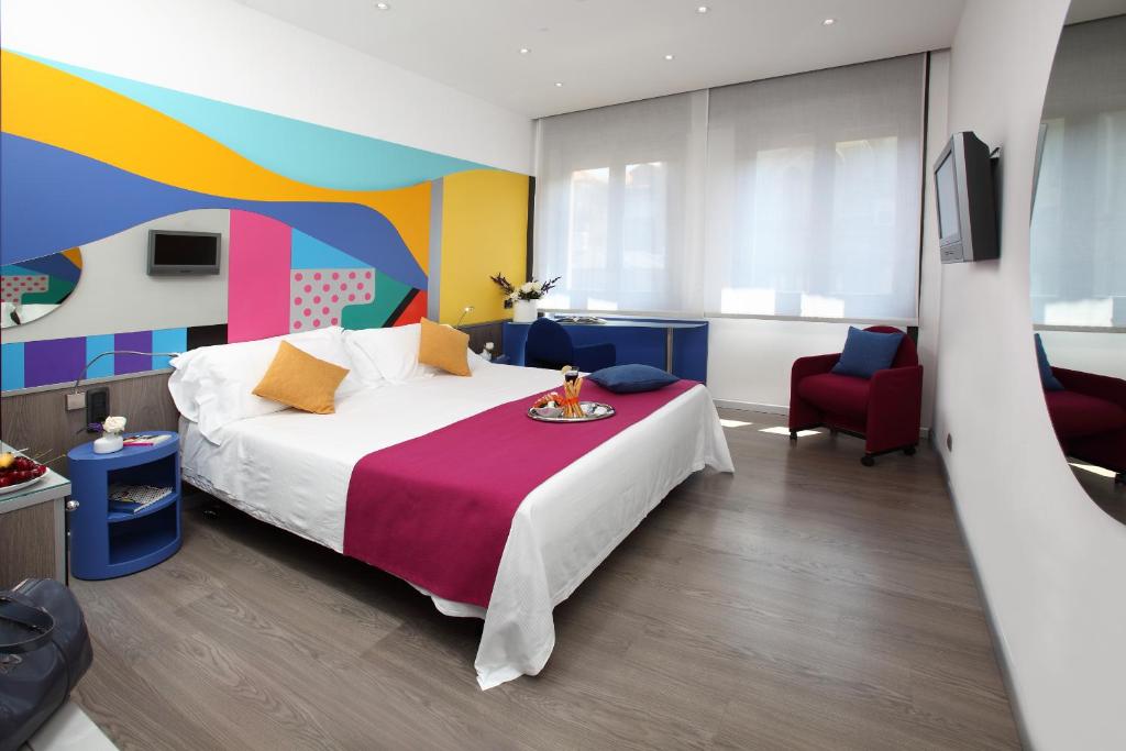 a bedroom with a bed and a colorful wall at Hotel Mediolanum in Milan