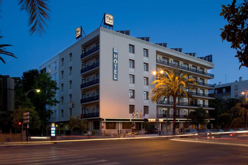 a large building with a clock on the side of it at NH Avenida Jerez in Jerez de la Frontera