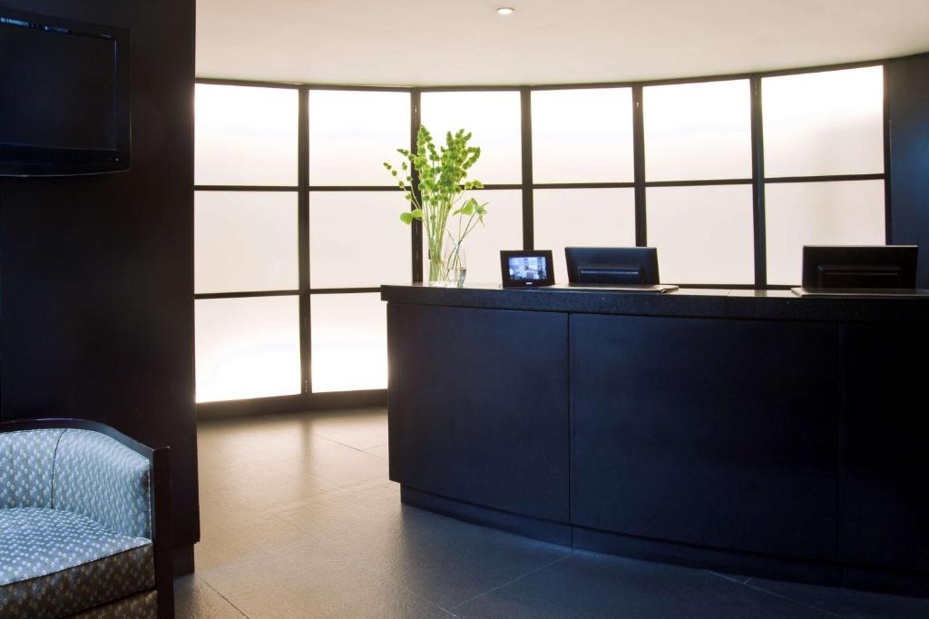 a lobby with a reception desk with a large window at NH Collection Buenos Aires Centro Histórico in Buenos Aires