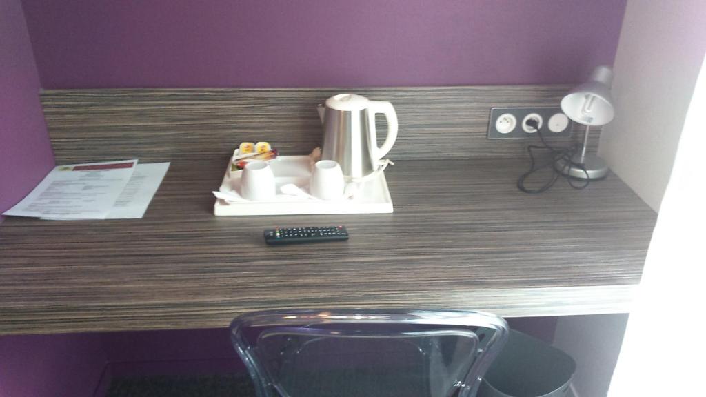 a counter top with a coffee pot on it at Logis Hôtel A la Bonne Auberge in Laval