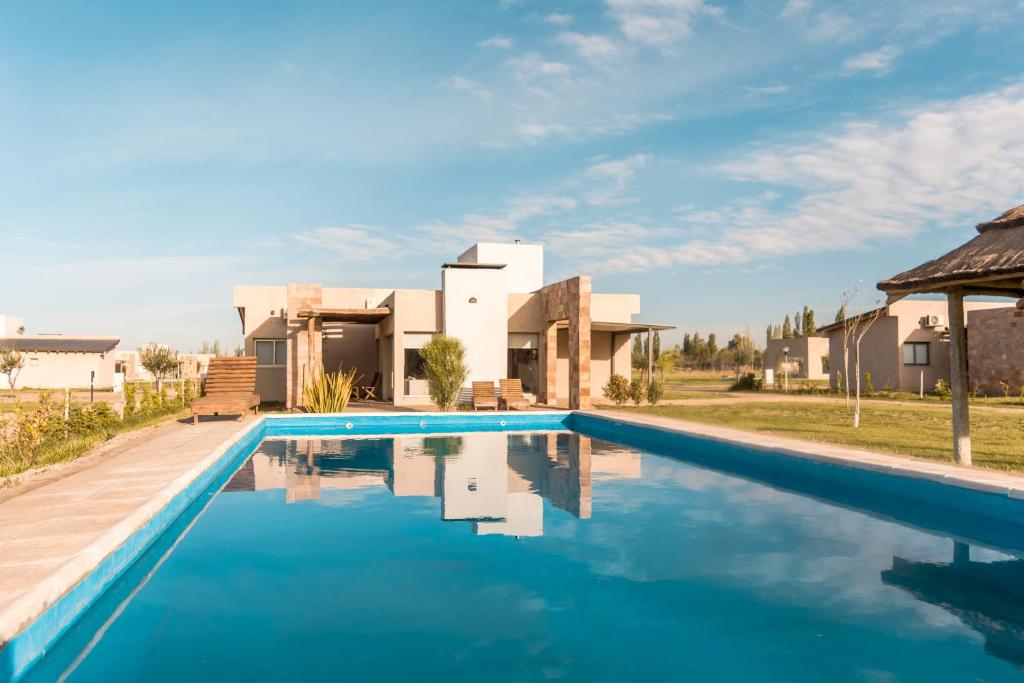 a swimming pool in front of a villa at Azalea Luxury Lodge in San Rafael