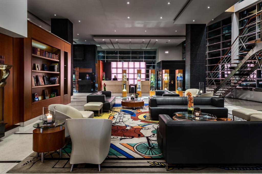 
a living room filled with furniture and a large window at Sofitel Montreal Golden Mile in Montreal
