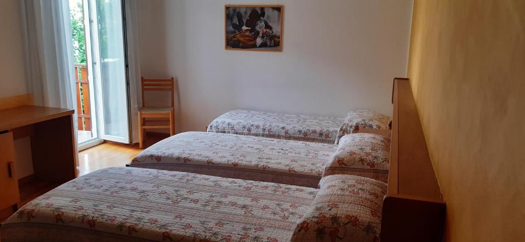 Postel nebo postele na pokoji v ubytování Garni Castel Ferari
