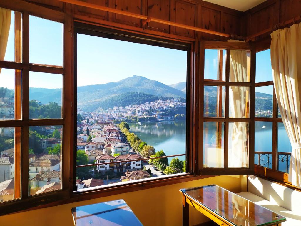 a room with windows with a view of a city at Guesthouse Filoxenia in Kastoria