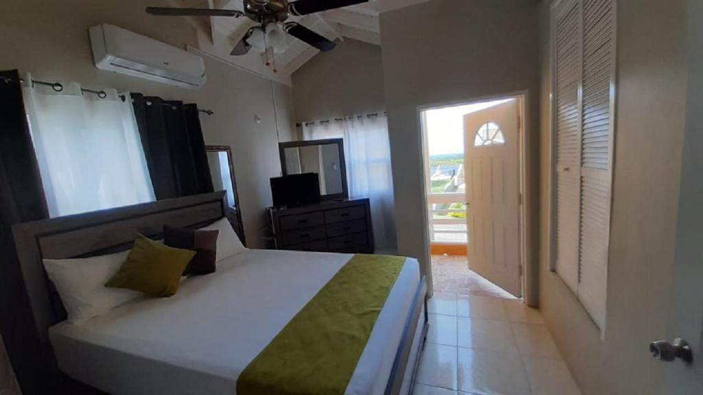 a bedroom with a bed and a television in it at Gorgeous hideout, close to tourist attractions in Jamaica in Belle Air Summit