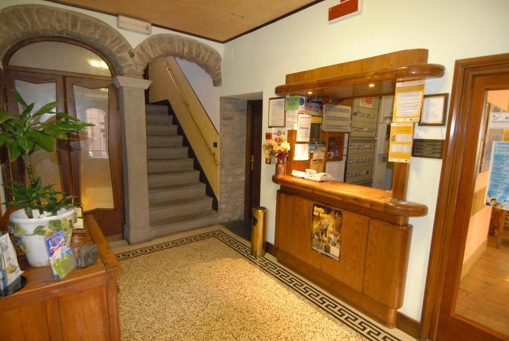 a room with a stairway and aoyer with a staircase at Albergo Ristorante Galli in Pievepelago
