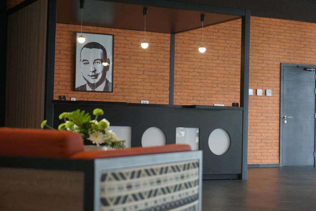 a room with a picture of a man on the wall at ONOMO Hotel Tanger Med in Tangier