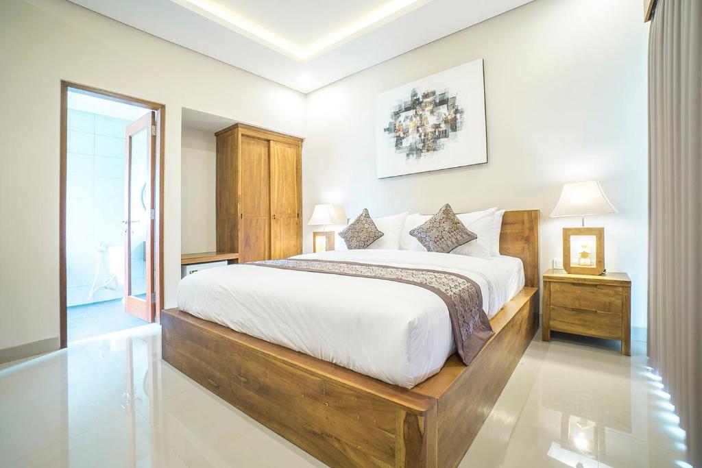 Postel nebo postele na pokoji v ubytování Putih DCarik Ubud