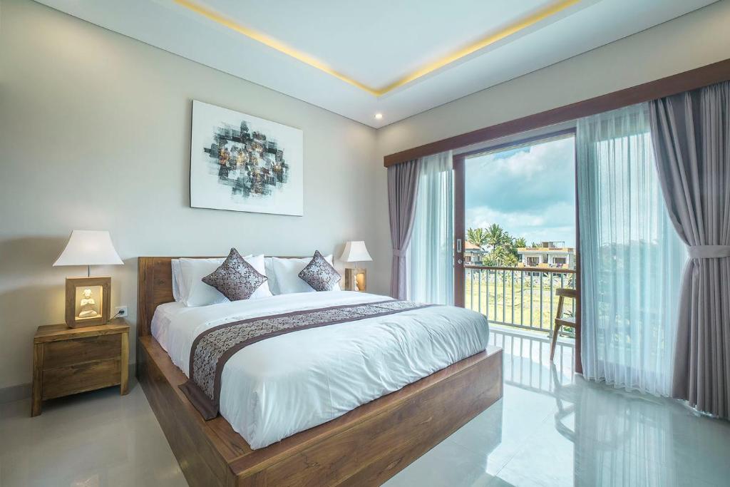 Postel nebo postele na pokoji v ubytování Putih DCarik Ubud