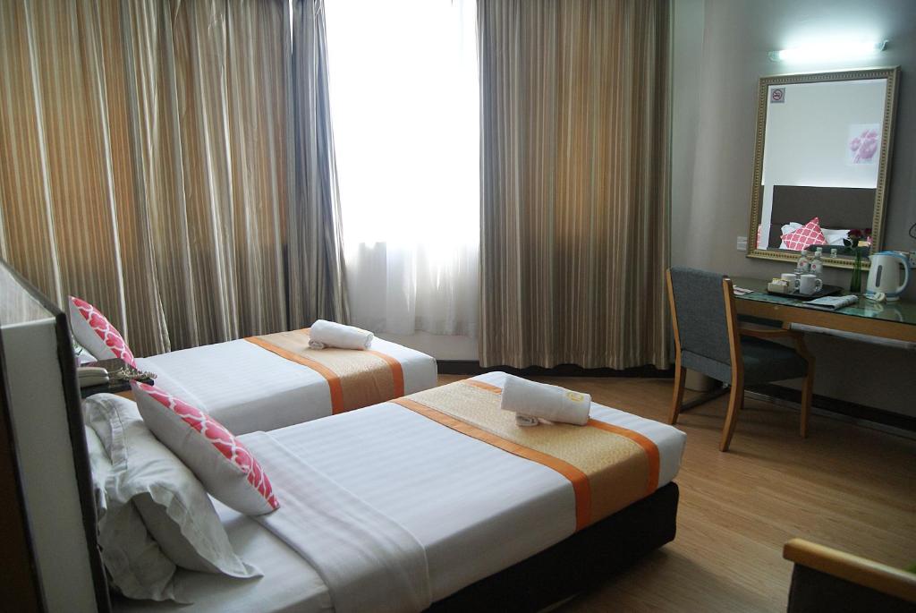 Postel nebo postele na pokoji v ubytování Tang Dynasty Hotel