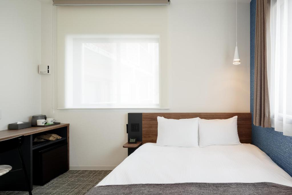 Postel nebo postele na pokoji v ubytování M's Hotel Kyoto Station Kizuya