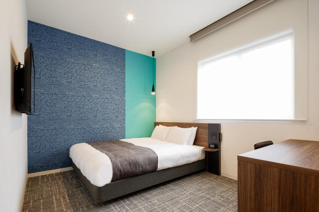 Postel nebo postele na pokoji v ubytování M's Hotel Kyoto Station Kizuya