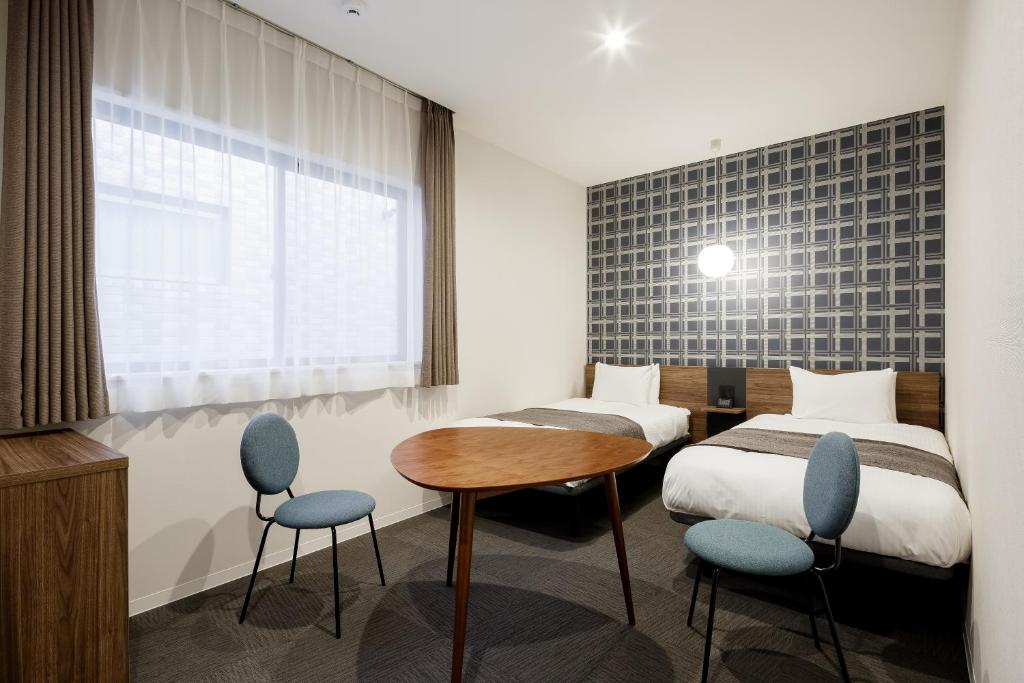 Postel nebo postele na pokoji v ubytování M's Hotel Kyoto Station Kizuya