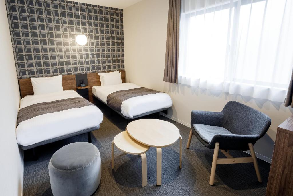 Postel nebo postele na pokoji v ubytování M's Hotel Kyoto Station Kizuya