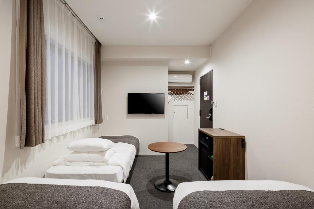 Postel nebo postele na pokoji v ubytování M's Hotel Kyoto Station Kizuya