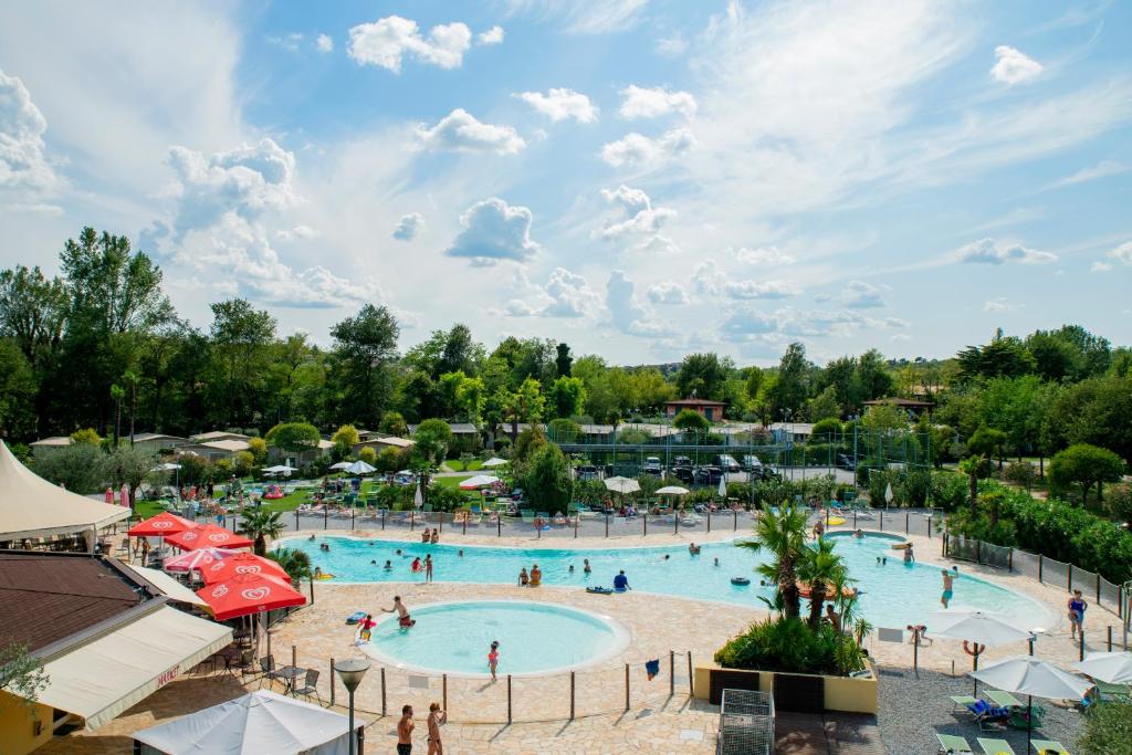 a large pool at a resort with people in it at Albatross Mobile Homes on Camping Baia Verde in Manerba del Garda