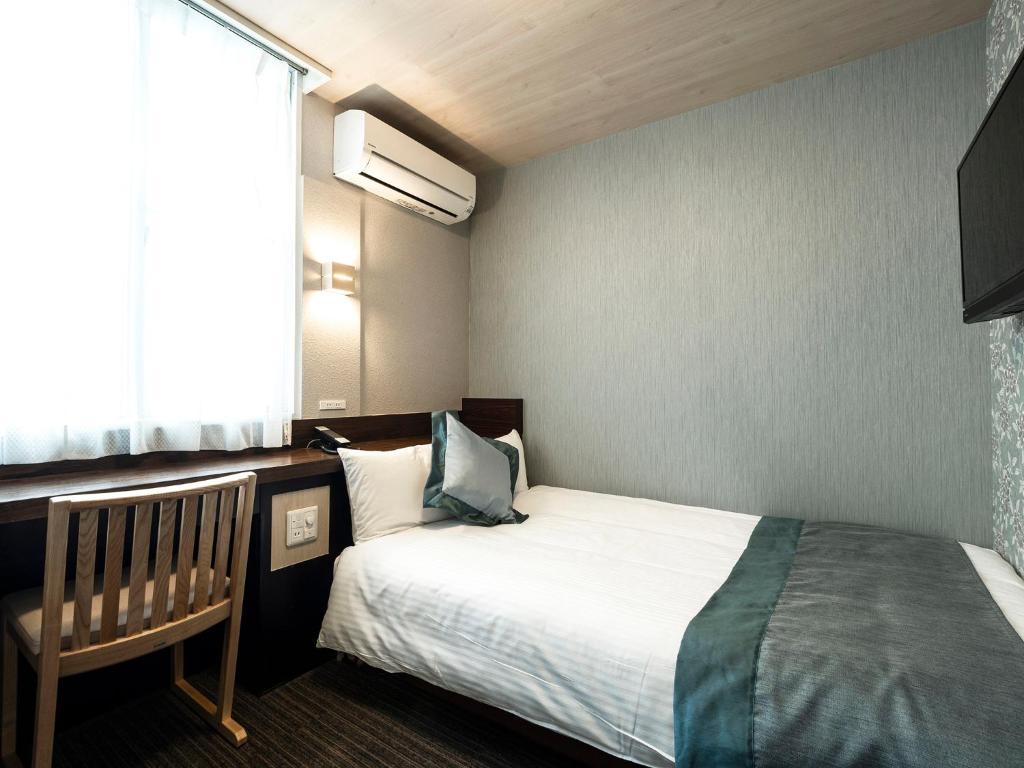 Postel nebo postele na pokoji v ubytování Hotel AreaOne Izumo