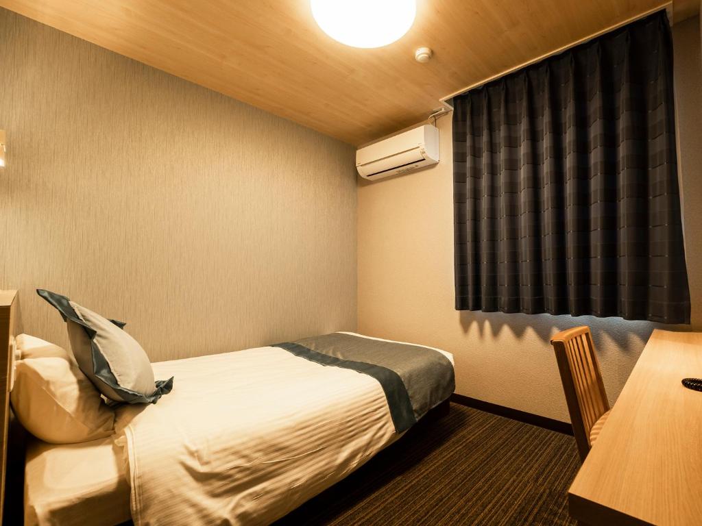 Postel nebo postele na pokoji v ubytování Hotel AreaOne Izumo