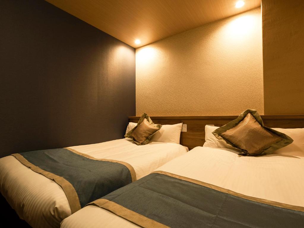 Postel nebo postele na pokoji v ubytování Hotel AreaOne Izumo