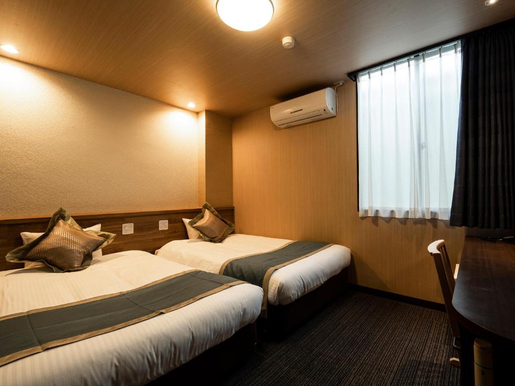 Postel nebo postele na pokoji v ubytování Hotel AreaOne Izumo