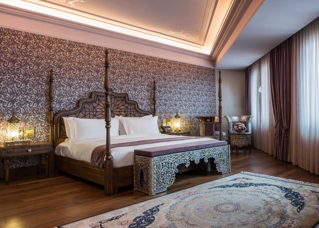 a bedroom with a canopy bed and a rug at AJWA Sultanahmet - Preferred Hotels LVX Collection in Istanbul