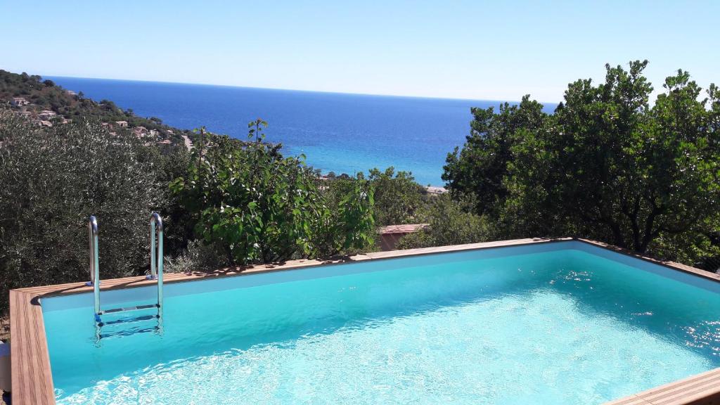 a swimming pool with a view of the ocean at Domise in Conca