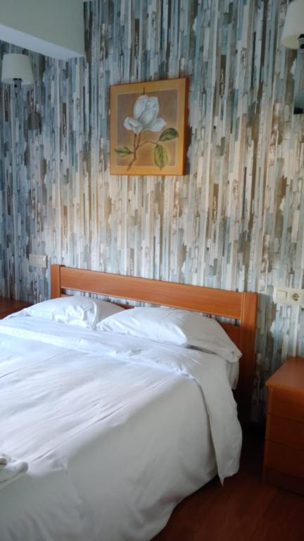 Postel nebo postele na pokoji v ubytování Hotel Camiño do Mar