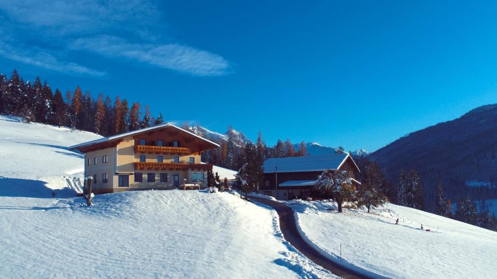 a building on top of a snow covered mountain at Sauschneidhof - Radstadt in Radstadt