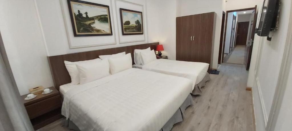 Postel nebo postele na pokoji v ubytování Hanoi Endless Hotel